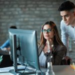 Professional IT support team collaborating in a modern bright Toronto office overlooking the city skyline