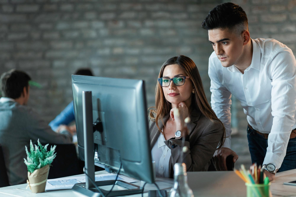 Professional IT support team collaborating in a modern bright Toronto office overlooking the city skyline